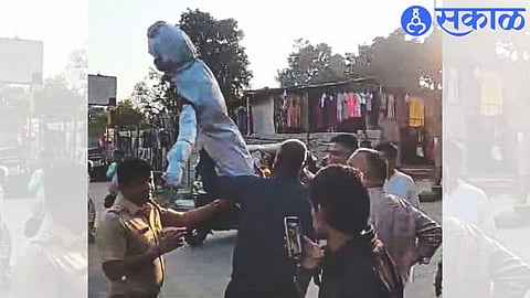 Police officers, staff while taking over the symbolic statue of MLA Nitesh Rane.
