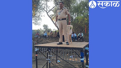 Police personnel patrolling from a roadside building during a road show on Chhatrapati Sambhajinagar Road.