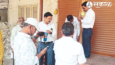 Municipal employees sealing the shops of the Agricultural Produce Market Committee