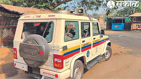 Police vehicle damaged and glass broken in mob attack.