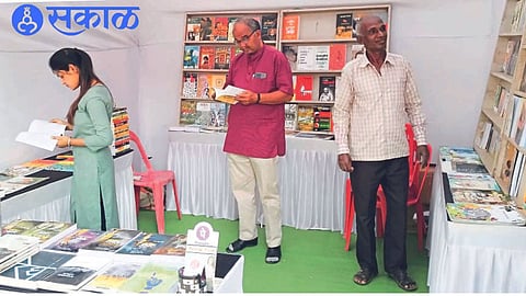 Readers inspecting books at a book festival.