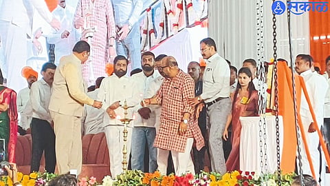 Chief Minister Eknath Shinde lighting the lamp during the Bhumi Pujan of the bridge over Tapi River connecting River.
