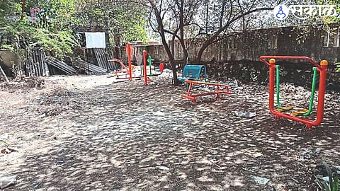 Green gym equipment in a pile of trash.