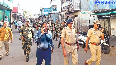 Police officers during a route march in Azad Nagar and Chalisgaon road police station limits in the wake of the Lok Sabha elections