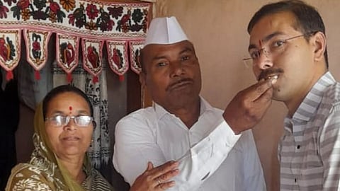 Father farmer Krushna Pagar, mother Sunita feeding Mahesh. 