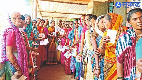 Self help group women queuing up to vote at a polling station.