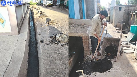 Sewers cleaned in city,  Sanitation workers scooping garbage from sewers