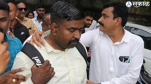 Suspect Vilas Narwade who was detained by the police while distributing money.