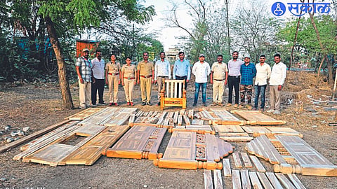Officers and staff of Forest Department with seized teak wood and furniture.