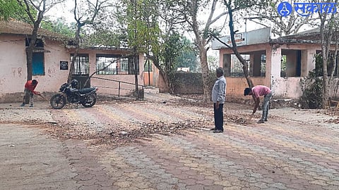 Employees cleaning the school premises on Friday.