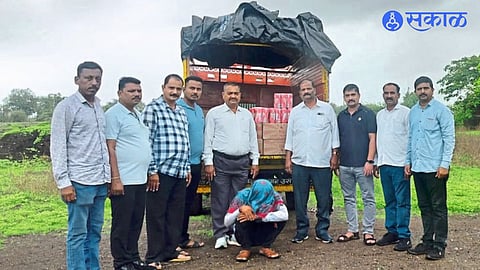 A team of State Excise Department with illegal liquor and arrested suspect.
