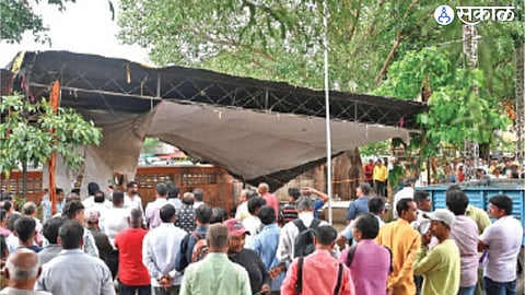 Workers removing the encroachment of Patra shed near the office of former MLA Vasant Gite on Tuesday.