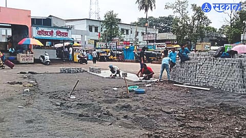 Pothole filling work in progress at bus station