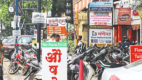 There is encroachment on the footpaths made for citizens in the city by parking signs of shops and vehicles.