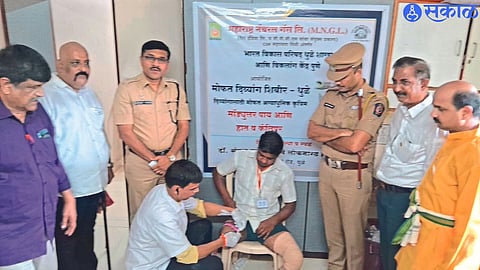Experts taking measurements of feet of disabled beneficiaries for prosthesis in a camp organized by Bharat Development Council and MNGL. Neighboring Superintendent of Police Shrikant Dhiware, Additional Superintendent of Police Kishore Kale and others.