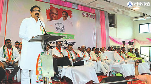 NCP (Sharad Chandra Pawar) state president Jayant Patil speaking at the workers meeting held on Sunday. Officials on stage. In the second photo, activists and officials present at the meeting.