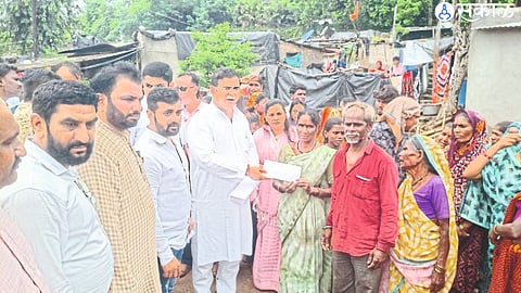 Jayakumar Rawal distributing financial aid to the flood victims. Neighbor officials.