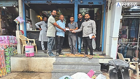 Municipal team collecting fines from shopkeepers after finding banned plastic goods.