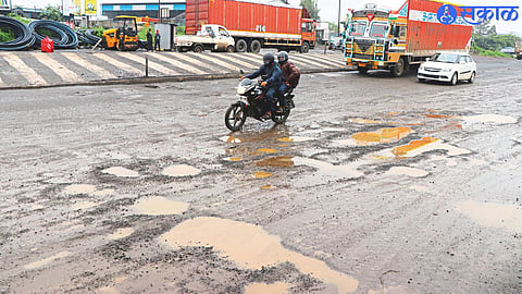 Big potholes on the Mumbai-Nashik highway with heavy traffic