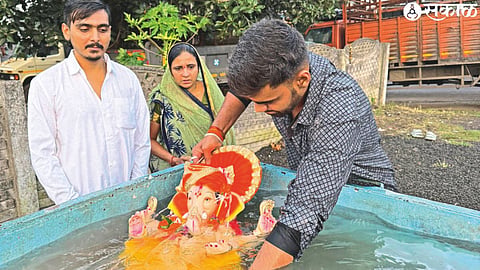 Citizens immerse a Ganesha idol in an artificial pond at Nandini river near ITI bridge on Sunday.