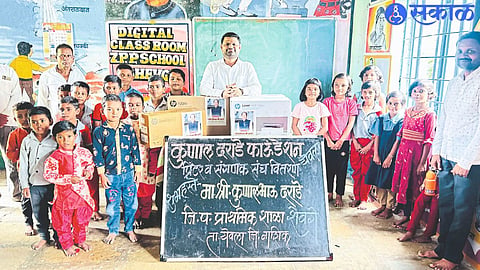 Kunal Darade with students during distribution of computer-printers to schools