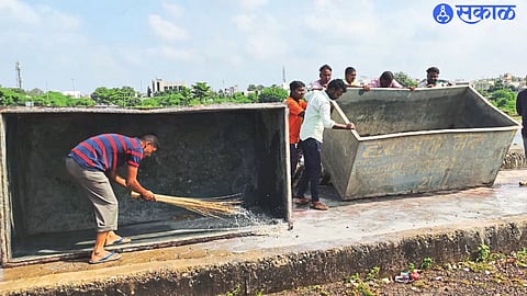 Municipal employees cleaning artificial ponds near Kumaranagar bridge for Ganesh idol immersion