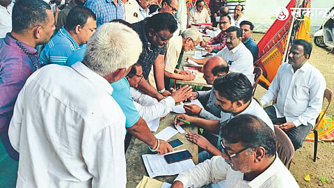 Municipal officials-employees while settling property tax arrears cases and implementing tax recovery process in National Lok Adalat in District Court.