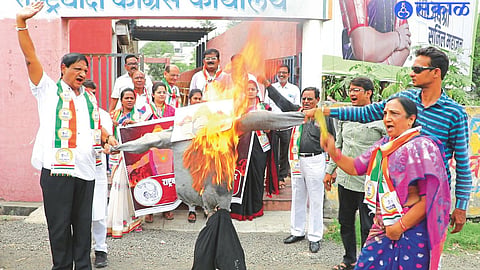 Mangala Patil, Valmik Patil and others while burning the symbolic effigy of Mahayuti's three-faced Ravana on Wednesday.