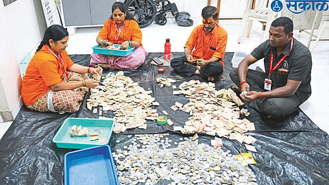 Officers and staff counting the cash after opening the fourth donation box at Kapaleswar temple