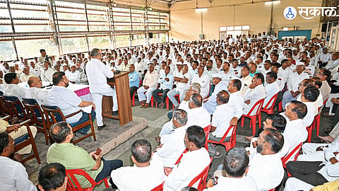 Balasaheb Patil addressing the gathering, urging members to stay proud and vigilant in his latest political speech.