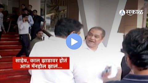 Amit Satam seen smiling during a discussion with opposition leader Jayant Patil