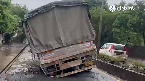 A truck got stuck in a deep pothole on Mundhwa's Tadigutta Road after allegedly poor sewer line restoration work.