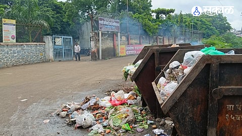 Garbage bins overflowing near the entrance of Padmashri Dr. Manibhai Desai Arts and Commerce College in Uruli Kanchan have triggered concerns over hygiene and student safety, with residents questioning the Gram Panchayat's waste management.