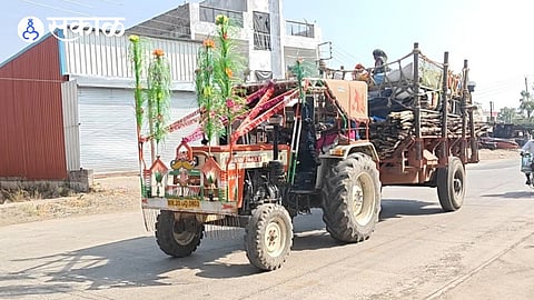Laborers traveling by tractor for sugarcane harvesting