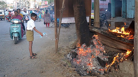 School Boy Effort To Control Fire Of Burning Tree   