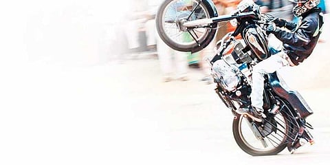 two wheeler stunting on the roads