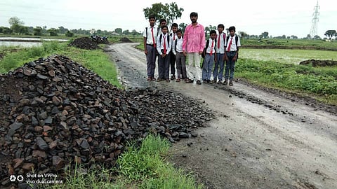 टेकाडी : रखडलेल्या रस्त्यावरून पायदळ शाळेत जाताना विद्यार्थी. 