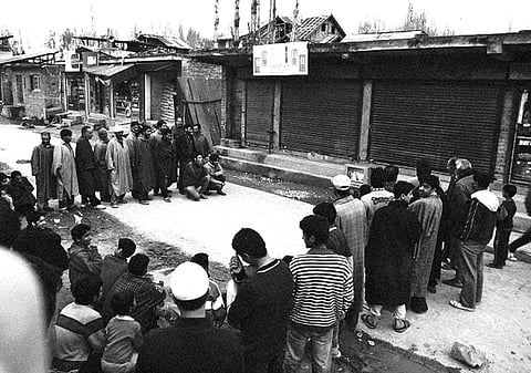 A crowd watching television during a curfew.
Adapted from an image by Flickr / Phillip Cotsfor.