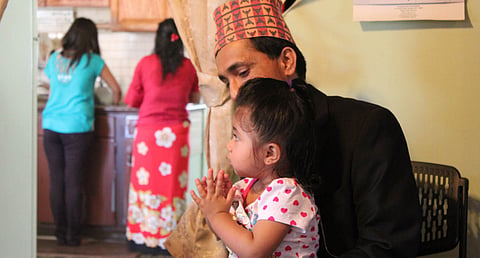 The eldest Regmi brother and his daughter prepare for Tihar.
Photo: Danielle Preiss
