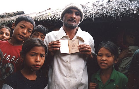A Lotshampa refugee at a camp in Jhapa District of eastern Nepal showing his Bhutanese passport.
Photo: Alemaugil / Wikimedia Common