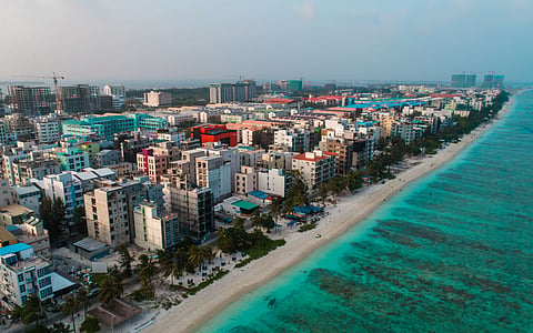 Buildings along the coast of the Maldives’ capital. Although essential services are often neglected in the country’s atolls, poverty and inequality are also rising in Malé. Photo: Ibrahim Mushan / Unsplash