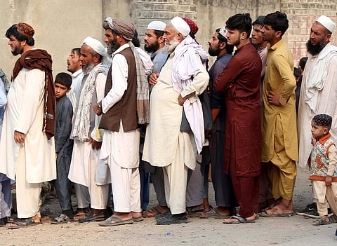 Afghan migrants wait for registration on the outskirts of northwest Pakistan’s Peshawar, Oct. 30, 2023. On 3 October, Pakistan’s government abruptly issued an order asking all foreigners living in the country without legal status to leave within 28 days or face deportation, a decision impacting undocumented Afghan migrants. But Afghan migrants have a long history in Pakistan, dating back to the 1970s. IMAGO/Xinhua. 