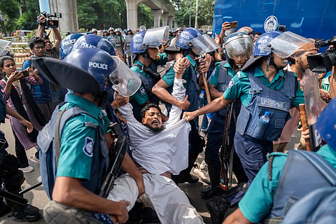 Police drag away a protestor during the anti-quota system uprising in Bangladesh. 