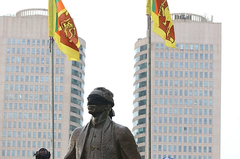 A statue of S W R D Bandaranaike blindfolded in protest during mass demonstrations in Sri Lanka in 2022. Bandaranaike founded the Sinhala Maha Sabha in 1937, and in 1956 passed the Sinhala Only Act, which marginalised Tamils and eventually led to targeted anti-Tamil violence.