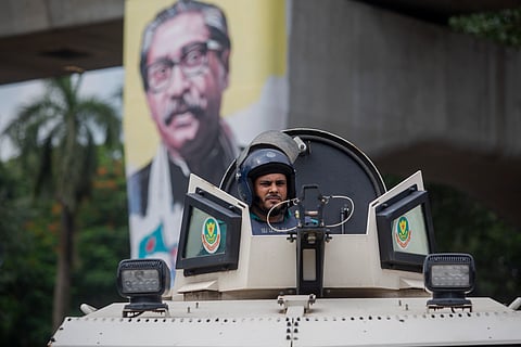 Police personnel take position at near Dhaka University during the demonstrations against Bangladesh's civil service hiring rules.