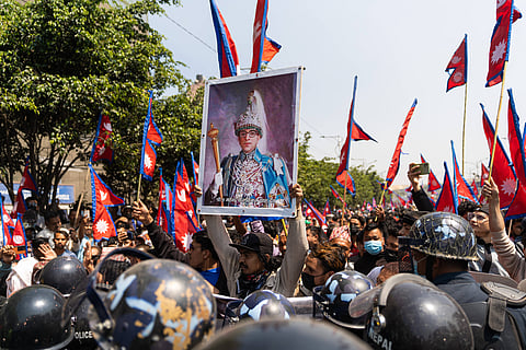 A pro-monarchist carries a poster of the late King Mahendra Shah during a protest in Kathmandu, Nepal 28 March. Resurgent royalists have political observers in Kathmandu wondering about the possibility of a return to monarchy in Nepal. 