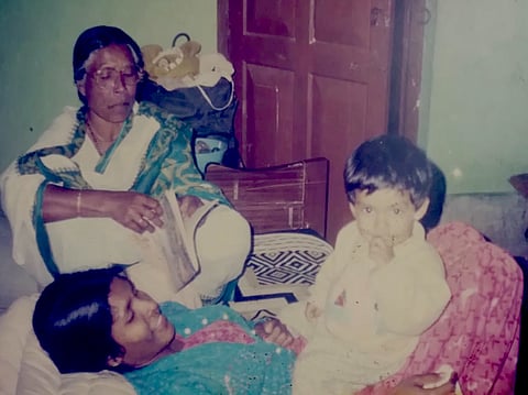 A young Anupam Debashish Roy with his paternal grandmother and aunt. They were among members of his family who adopted Brahmin myths and names to pursue reading and education, practices once considered taboo for people from the Namasudra caste. 