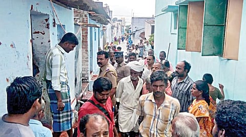 குருசாமிபாளையத்தில் கொலை செய்யப்பட்ட பெண்ணின் வீட்டின் முன்பு திரண்டிருந்த கிராம மக்கள்.