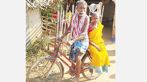 தனது குடிசை வீட்டின் முன் மனைவி மஞ்சுளாவுடன் அறிவழகன்.