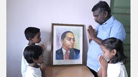 மதுரையில் உள்ள ஒரு வீட்டில் அண்ணல் அம்பேத்கர் படத்துக்கு தந்தையுடன் சேர்ந்து மரியாதை செலுத்திய குழந்தைகள்.